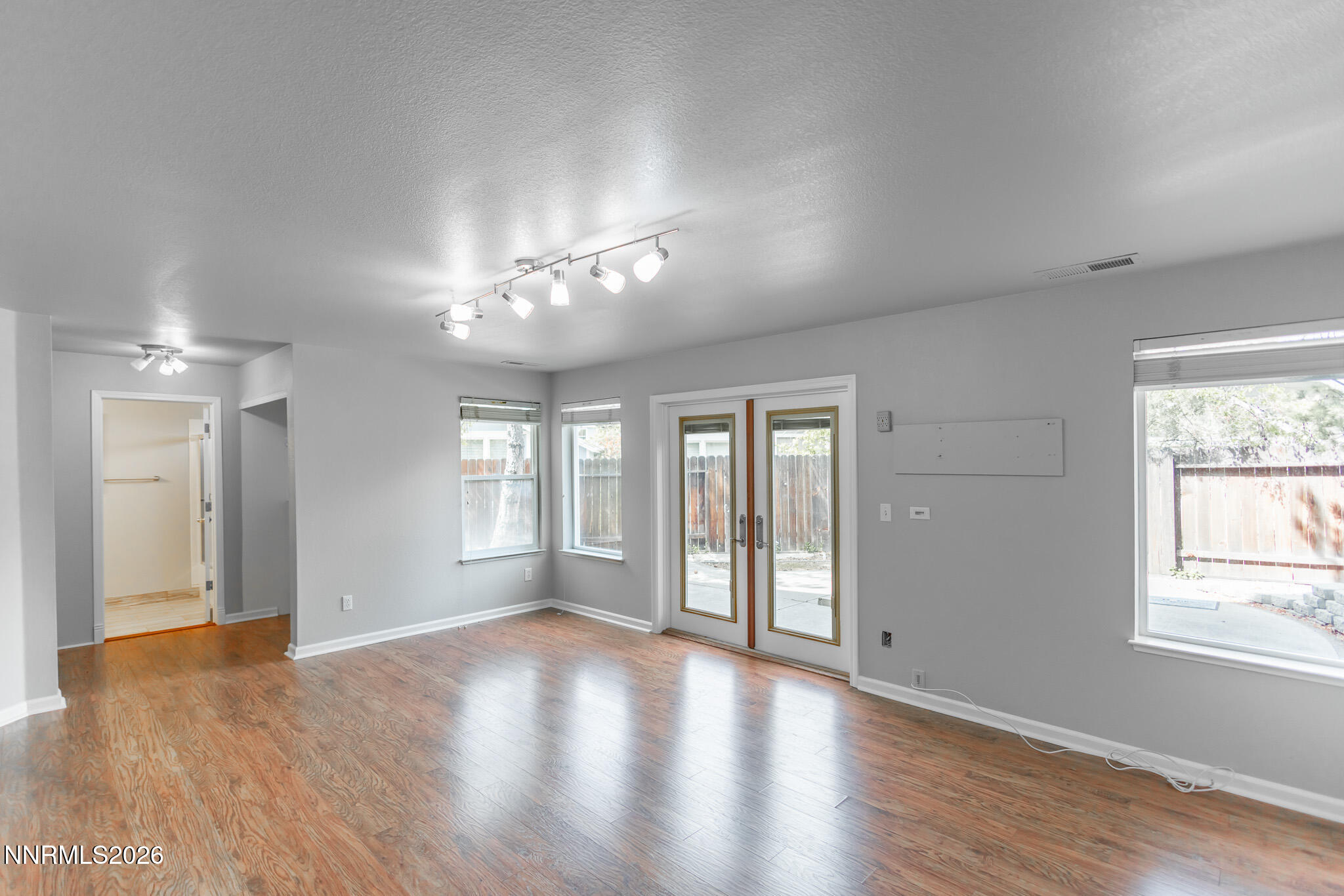4775 Cedarhill Lane Reno, NV 89519 - Photo 39 of 63 a view of an empty room with wooden floor and a window
