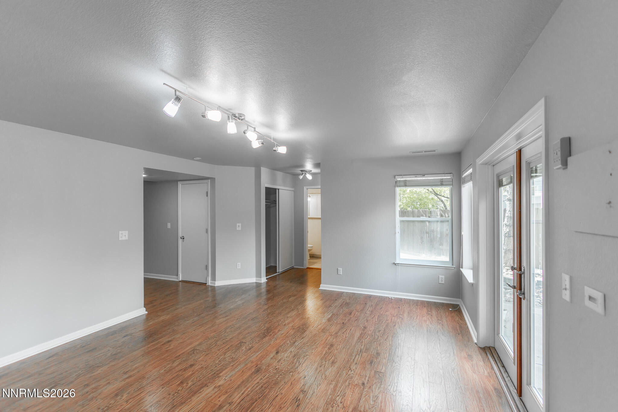 4775 Cedarhill Lane Reno, NV 89519 - Photo 40 of 63 a view of an empty room with wooden floor and a window
