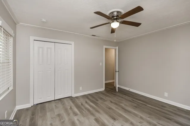 a view of an empty room with wooden floor