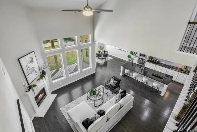 a living room with furniture and a floor to ceiling window
