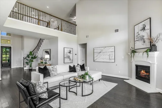 a living room with furniture a fireplace and a window