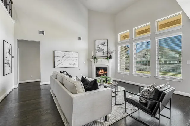 a living room with furniture a fireplace and a large window