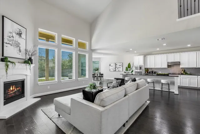a living room with furniture wooden floor and a fireplace