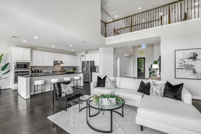 a living room with furniture kitchen view and a dining table