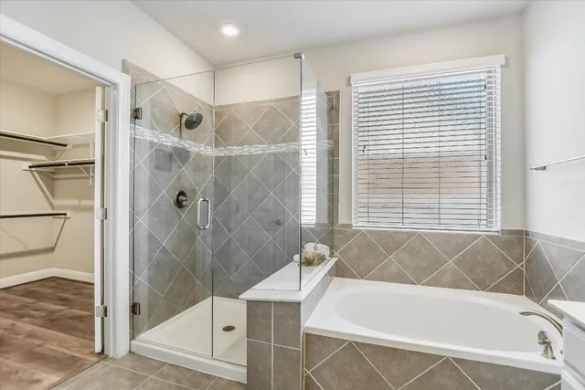 a bathroom with a bathtub and shower