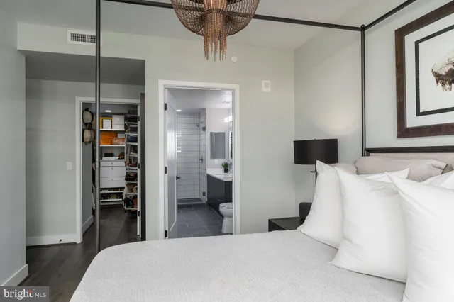 a bedroom with a bed and a view of walk in closet