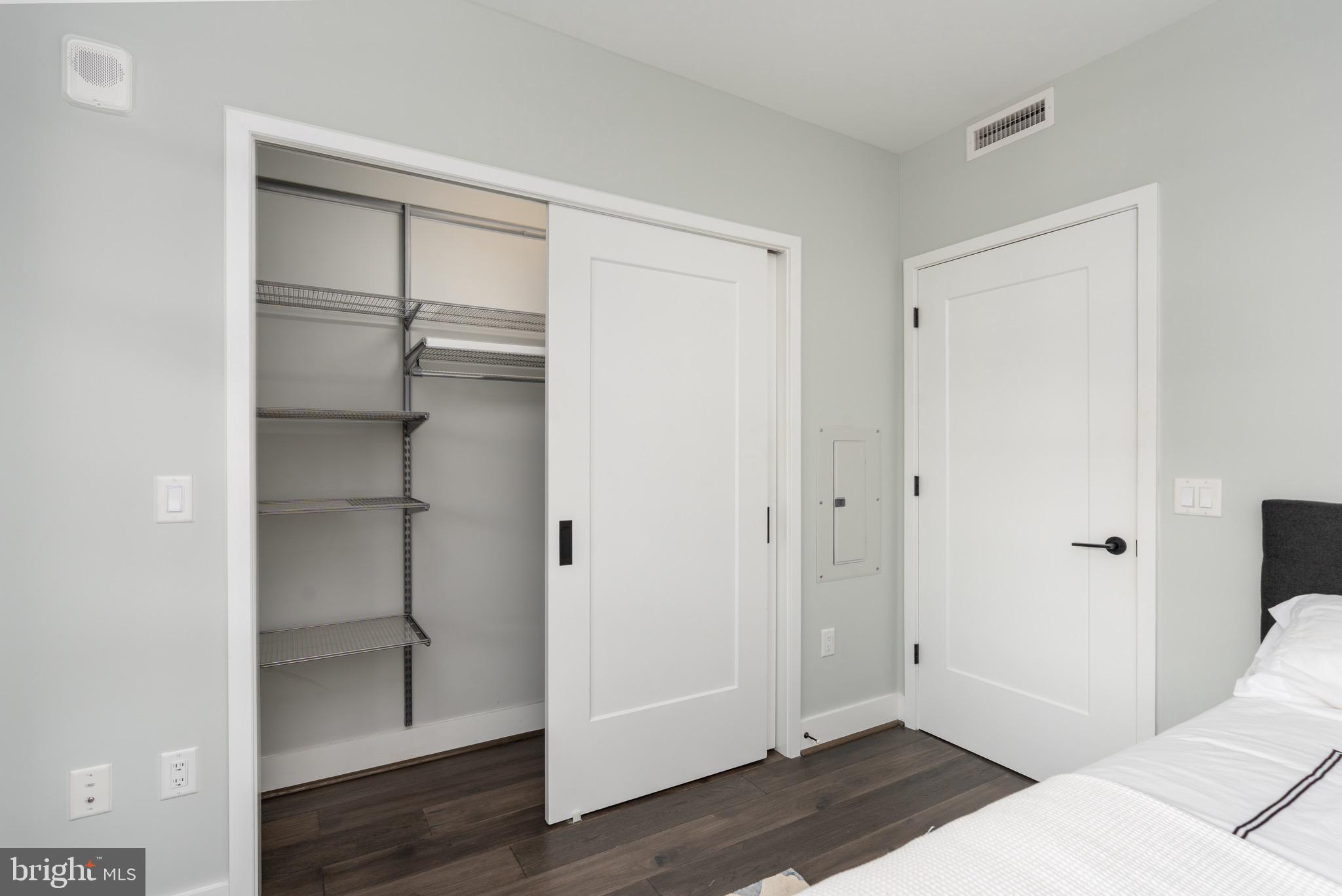 1300 4th Street Southeast, Unit 715 Washington, DC 20003 - Photo 22 of 47 a bedroom with a bed and wooden floor