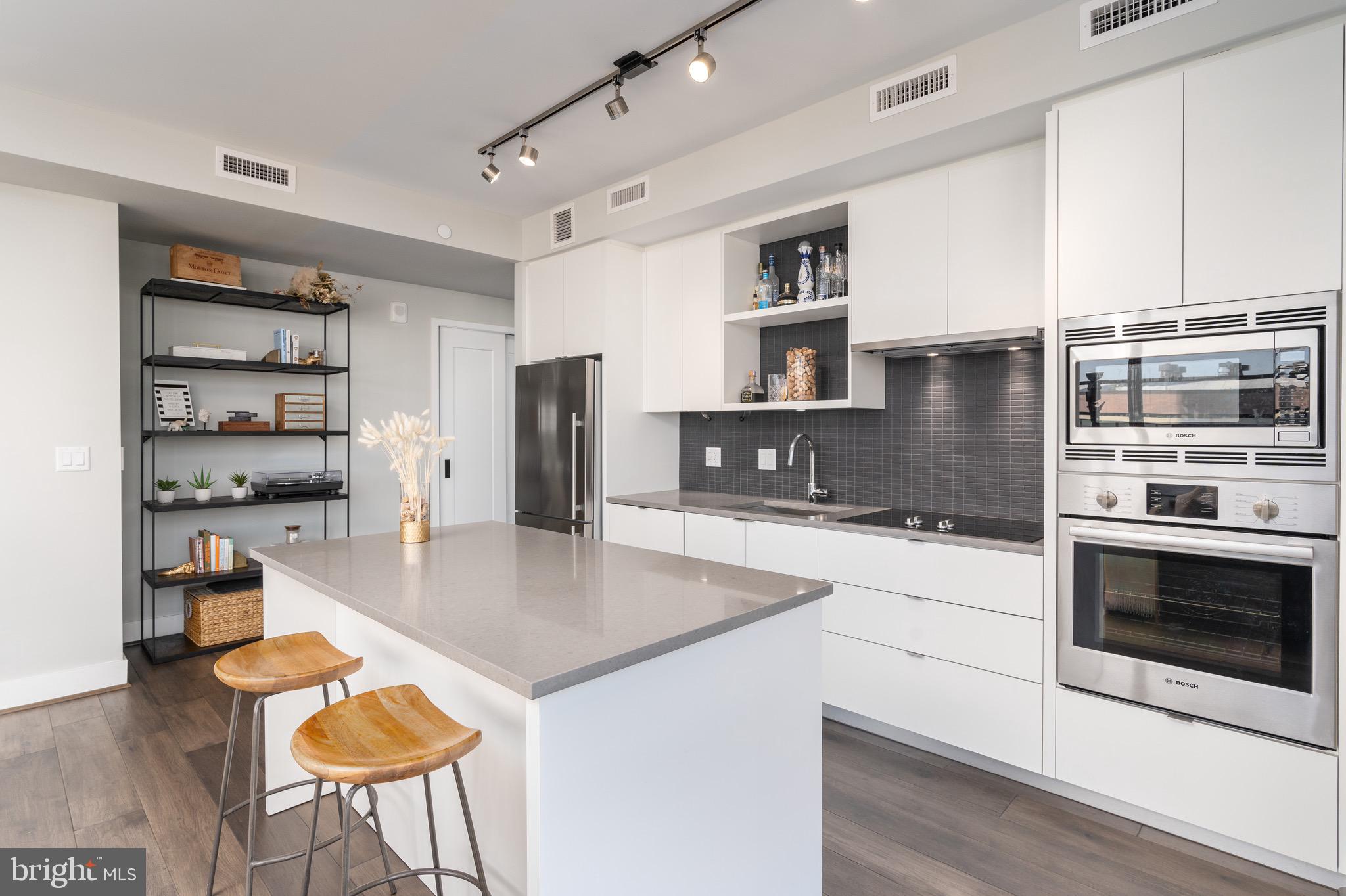 1300 4th Street Southeast, Unit 715 Washington, DC 20003 - Photo 7 of 47 a kitchen with stainless steel appliances granite countertop a stove top oven a sink a counter space and cabinets