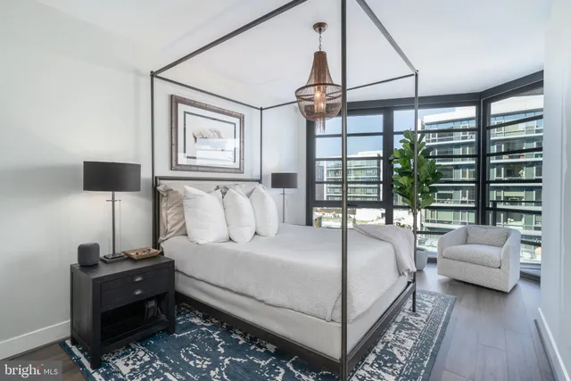 a bedroom with a large bed and a chandelier