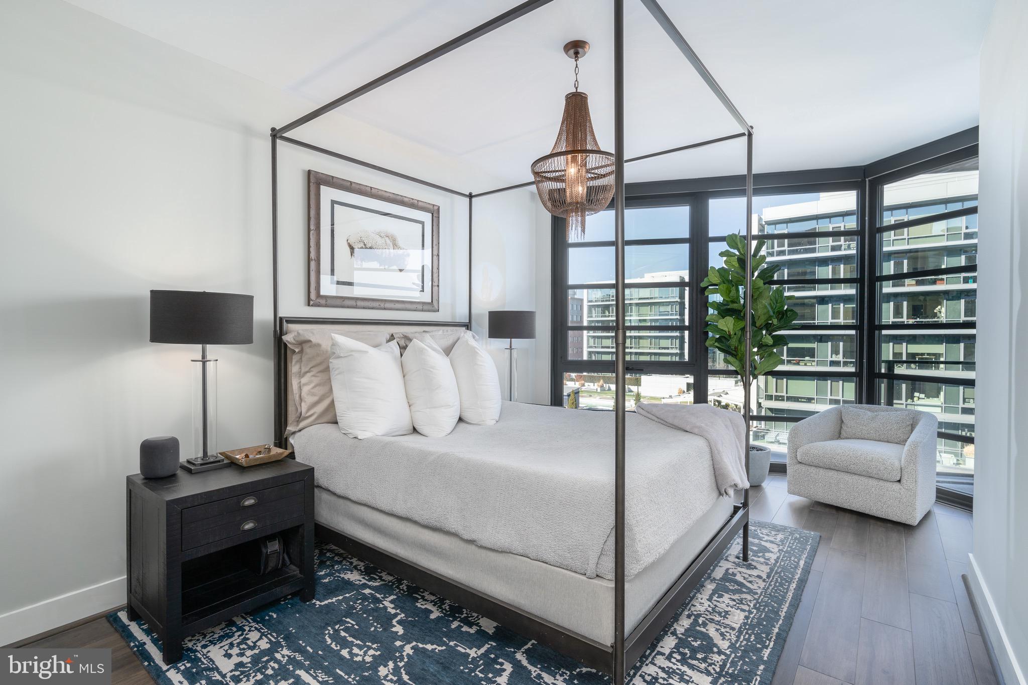 1300 4th Street Southeast, Unit 715 Washington, DC 20003 - Photo 8 of 47 a bedroom with a large bed and a chandelier
