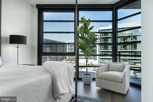a bedroom with furniture and a potted plant