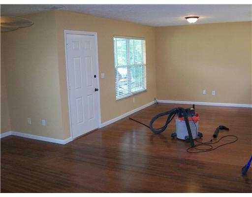 1050 Southwest Fenway Road Port St. Lucie, FL 34953 - Photo 9 of 11 a view of a livingroom with wooden floor and window