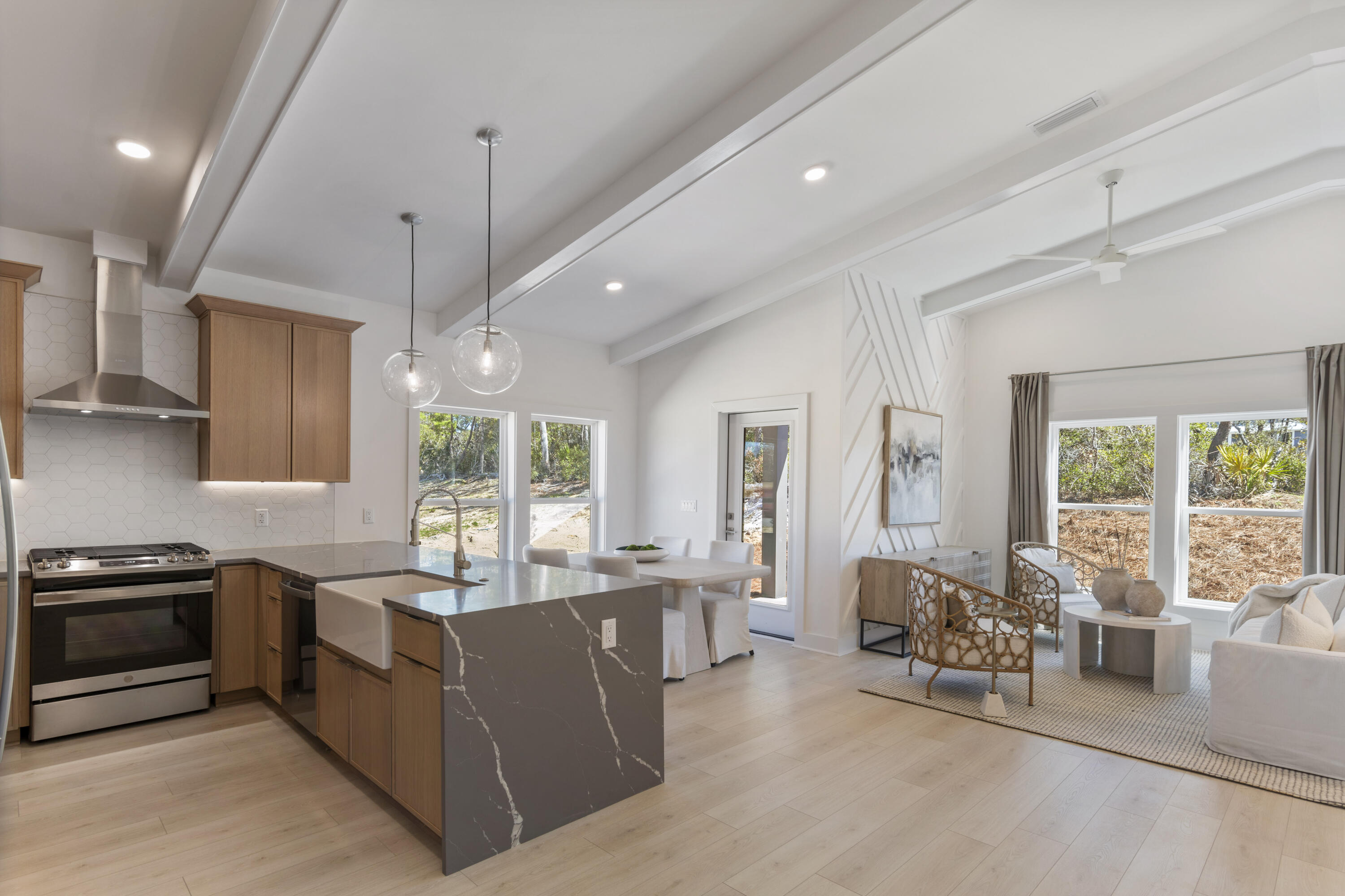 31 Asher St Inlet Beach, Unit LOT 43 Inlet Beach, FL 32461 - Photo 8 of 44 a large kitchen with kitchen island a large window cabinets and stainless steel appliances