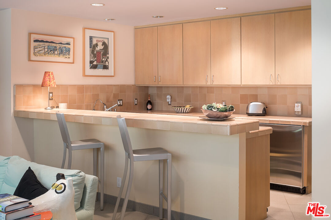 12309 Viewcrest Road Studio City, CA 91604 - Photo 26 of 52 a utility room with a sink a cabinets and washer dryer