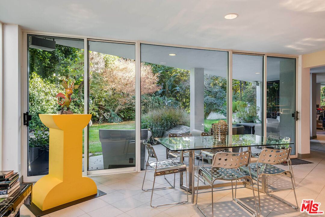 12309 Viewcrest Road Studio City, CA 91604 - Photo 29 of 52 a dining room with furniture and a floor to ceiling window