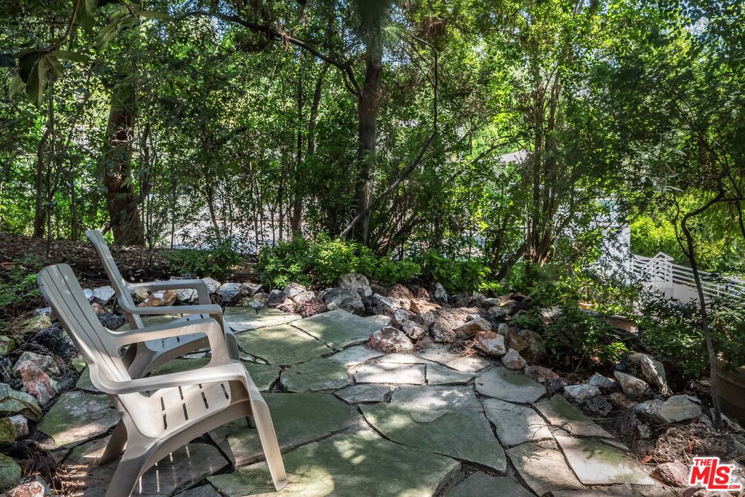 12309 Viewcrest Road Studio City, CA 91604 - Photo 42 of 52 a view of a chairs and table in a backyard