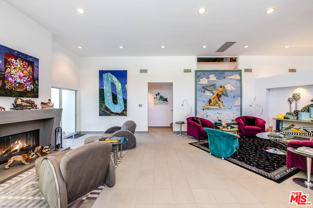 12309 Viewcrest Road Studio City, CA 91604 - Photo 7 of 52 a living room with furniture a flat screen tv and a fireplace