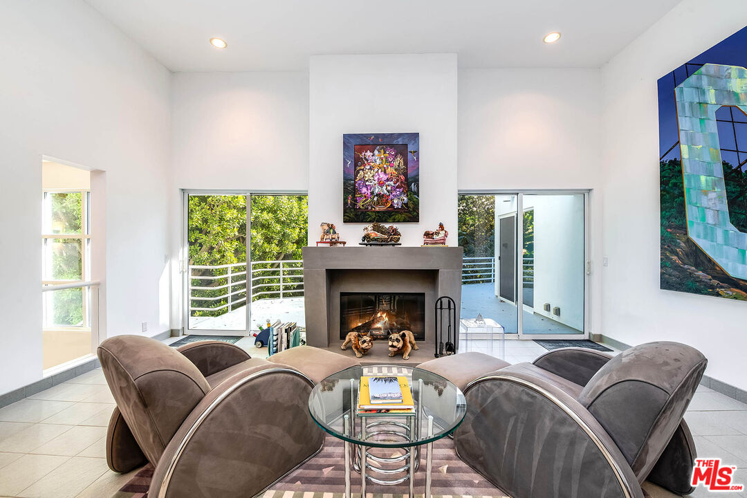 12309 Viewcrest Road Studio City, CA 91604 - Photo 8 of 52 a living room with furniture a fireplace and a large window