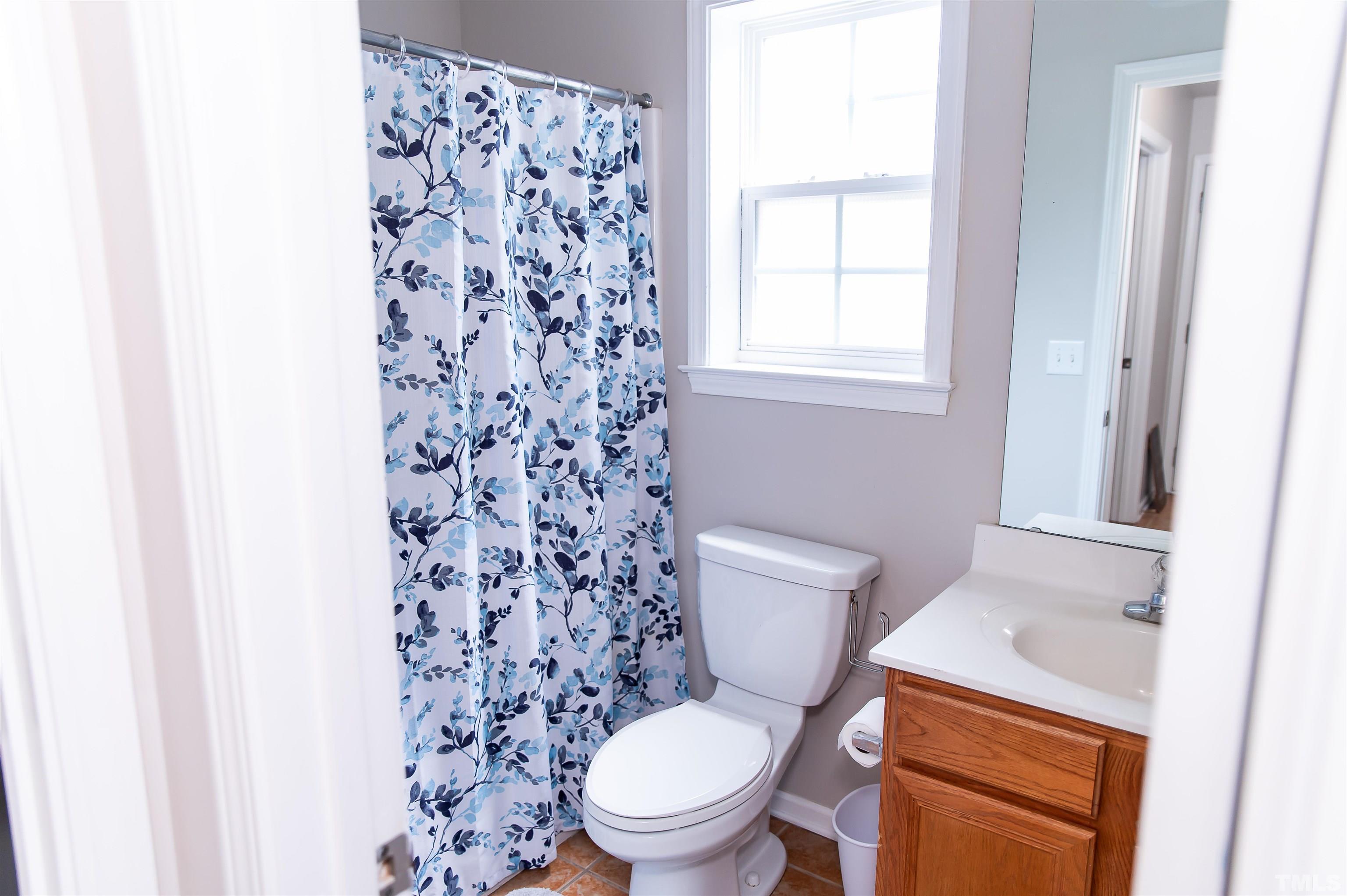 917 Pristine Lane Rolesville, NC 27571 - Photo 11 of 35 a white toilet sitting next to a bathroom sink