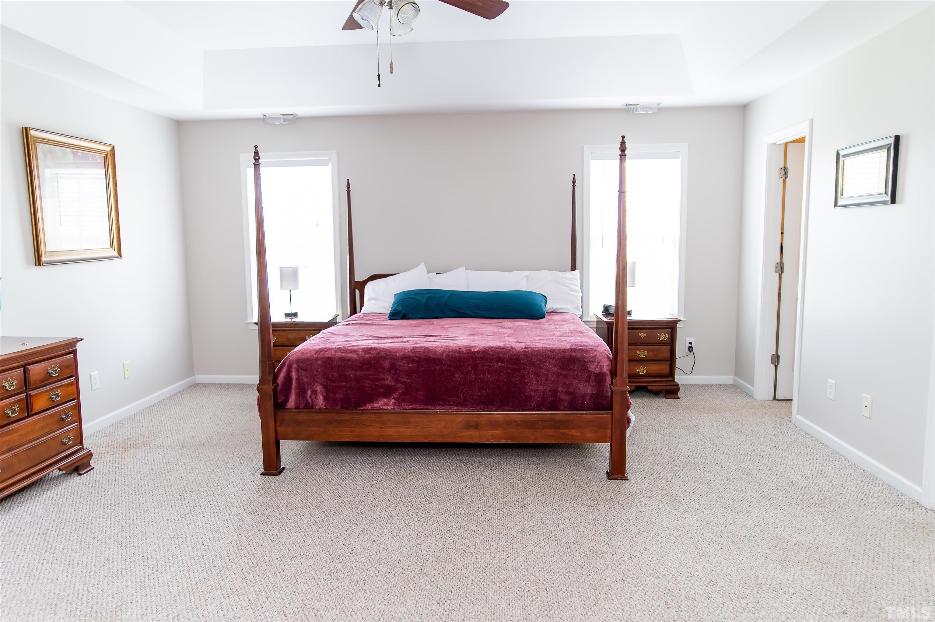 917 Pristine Lane Rolesville, NC 27571 - Photo 21 of 35 a bedroom with a bed and a cabinets