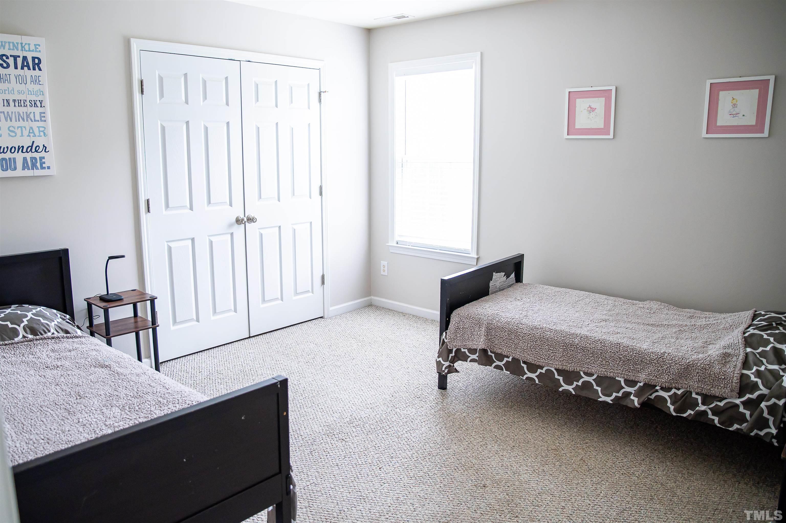 917 Pristine Lane Rolesville, NC 27571 - Photo 30 of 35 a bedroom with a bed and dresser