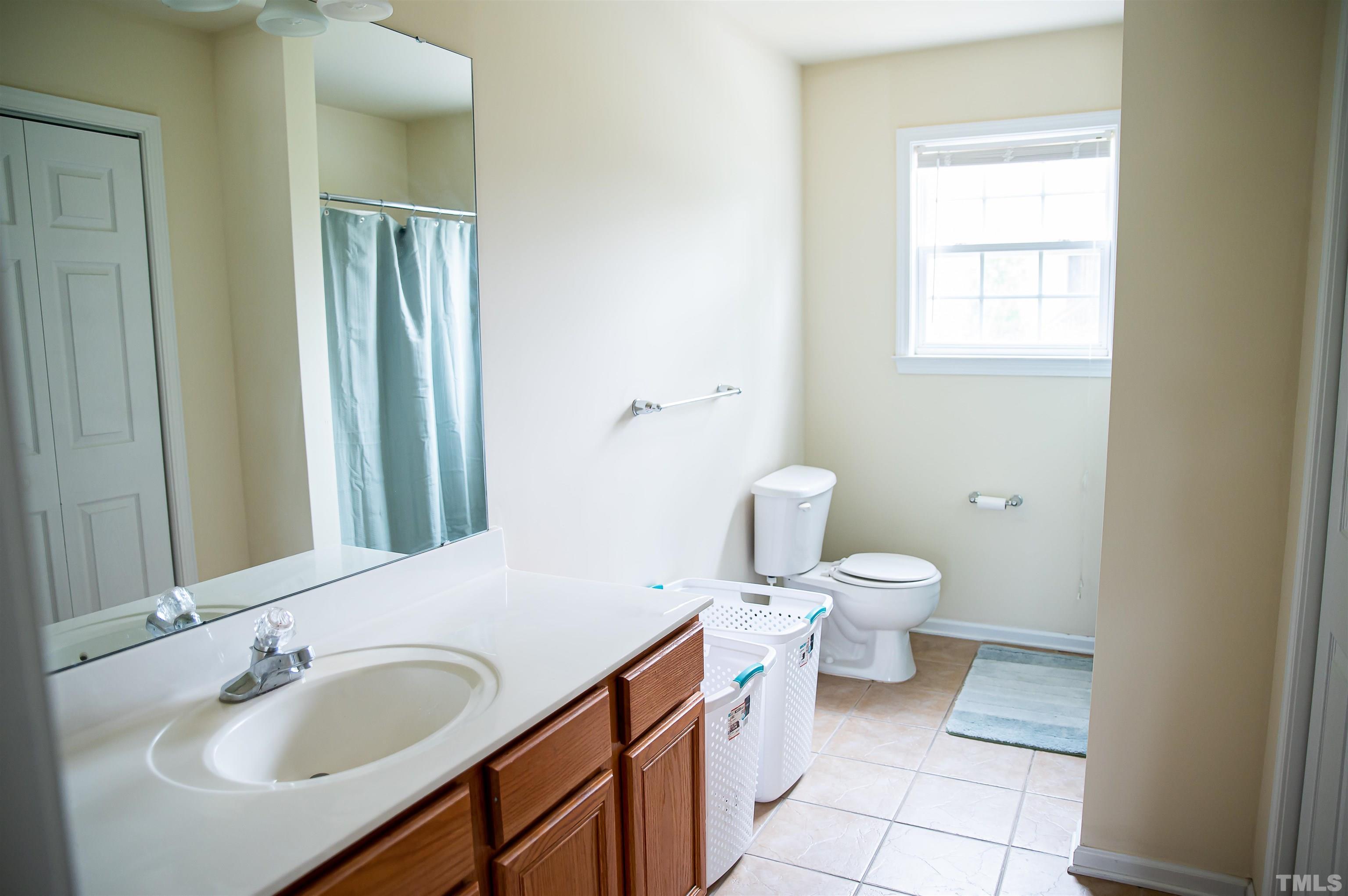 917 Pristine Lane Rolesville, NC 27571 - Photo 31 of 35 a bathroom with a toilet sink and mirror