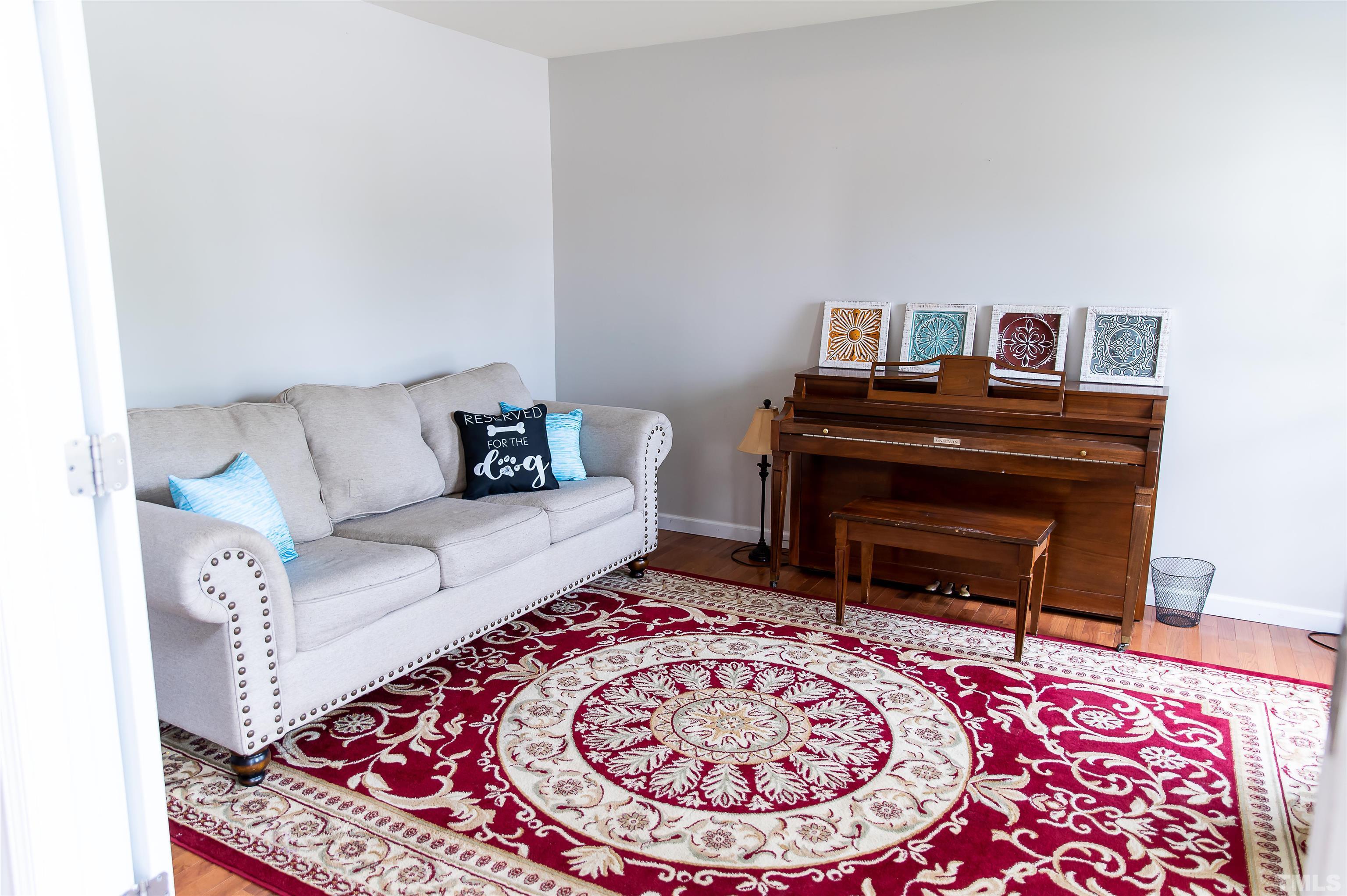 917 Pristine Lane Rolesville, NC 27571 - Photo 4 of 35 a living room with a couch and a piano on it