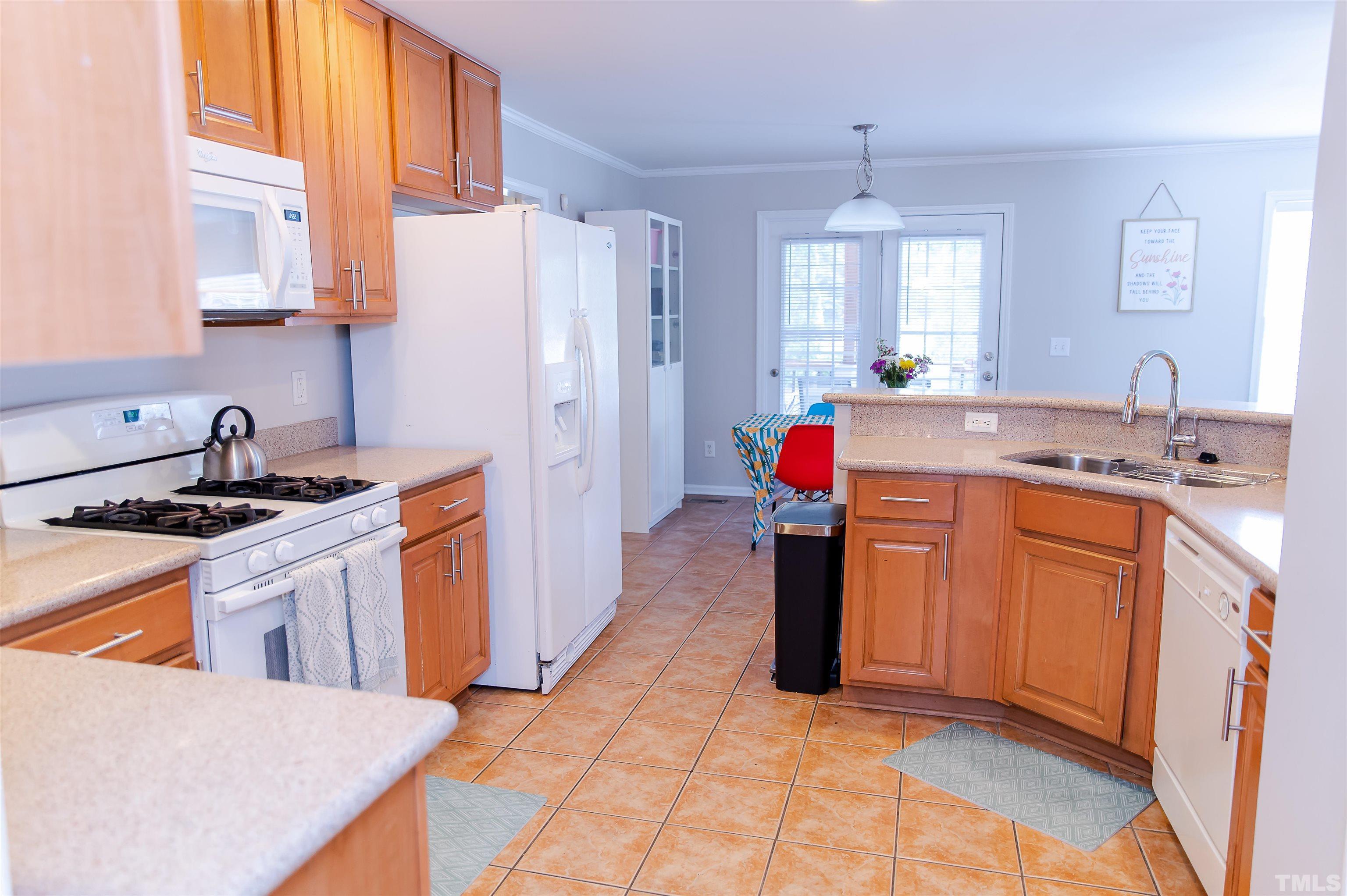 917 Pristine Lane Rolesville, NC 27571 - Photo 7 of 35 a kitchen with stainless steel appliances granite countertop a sink stove and refrigerator