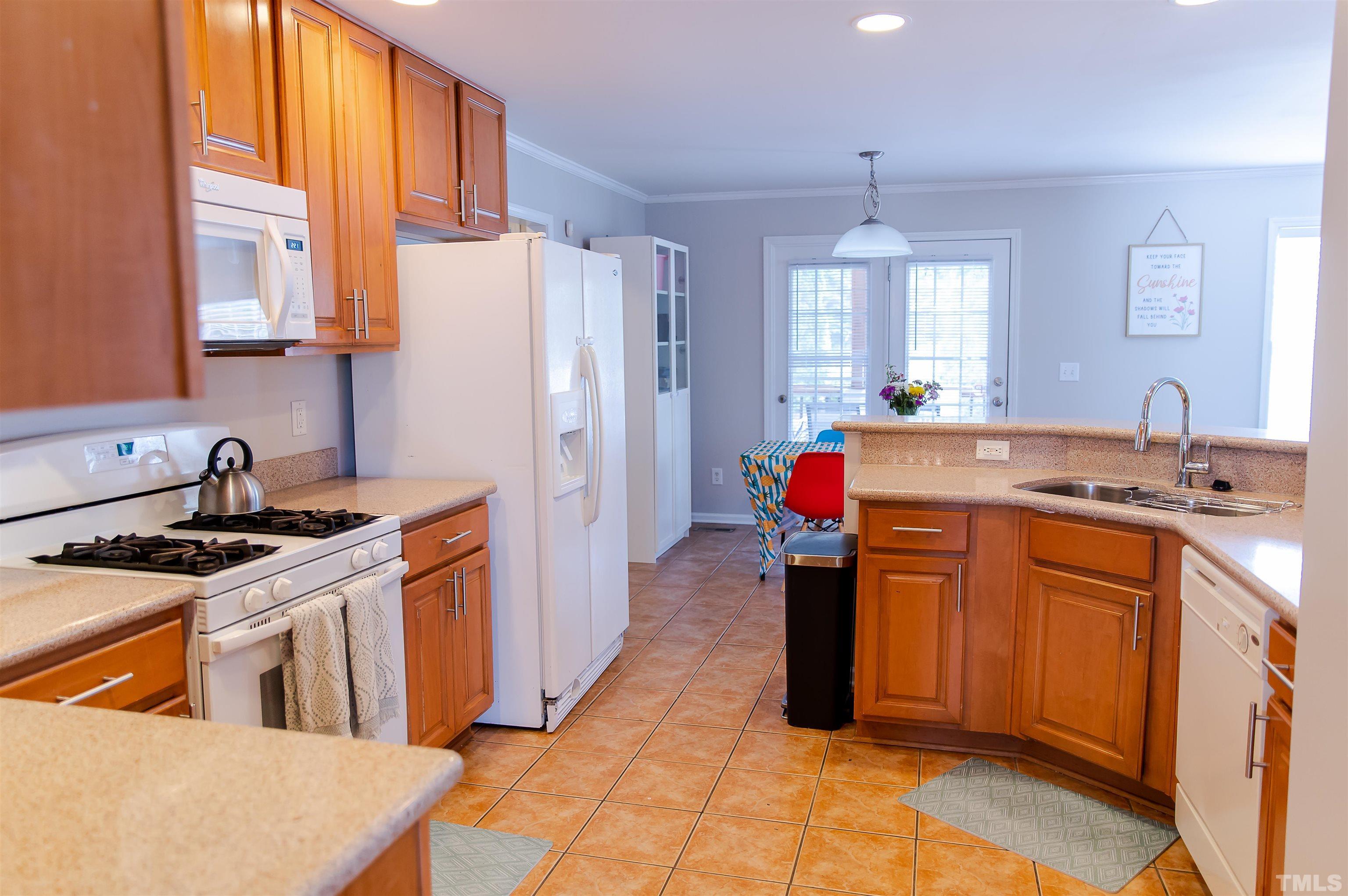 917 Pristine Lane Rolesville, NC 27571 - Photo 8 of 35 a kitchen with stainless steel appliances granite countertop a sink stove and refrigerator