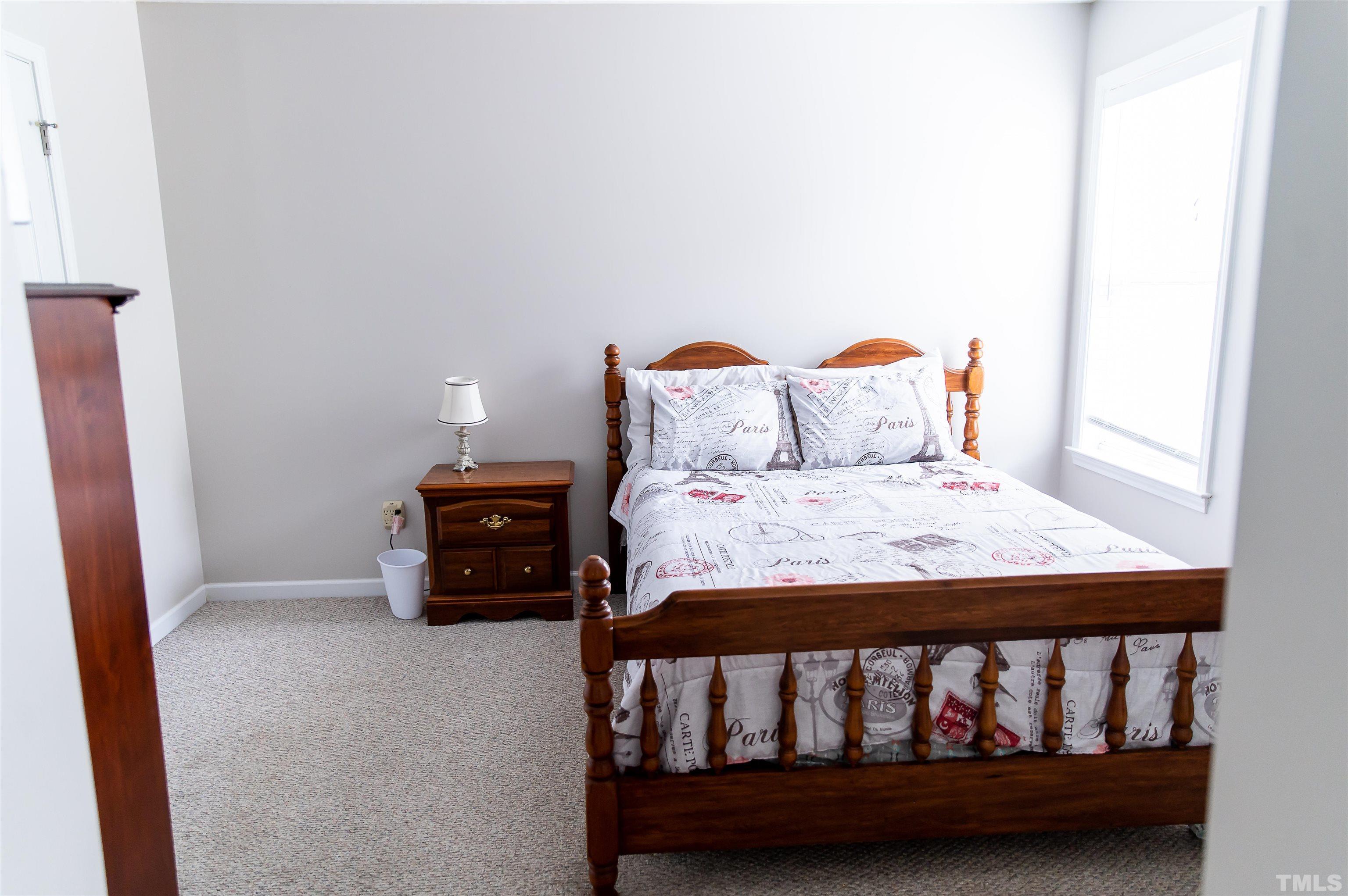 917 Pristine Lane Rolesville, NC 27571 - Photo 10 of 35 a bed sitting in a bedroom next to a window