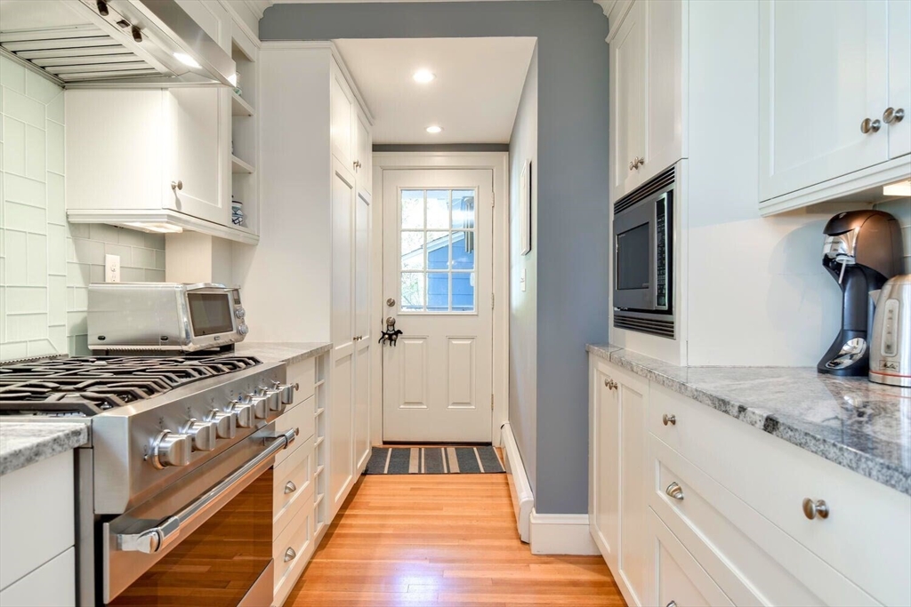 15 Selden Street Newton, MA 02468 - Photo 12 of 33 a kitchen with stainless steel appliances granite countertop a stove and a sink