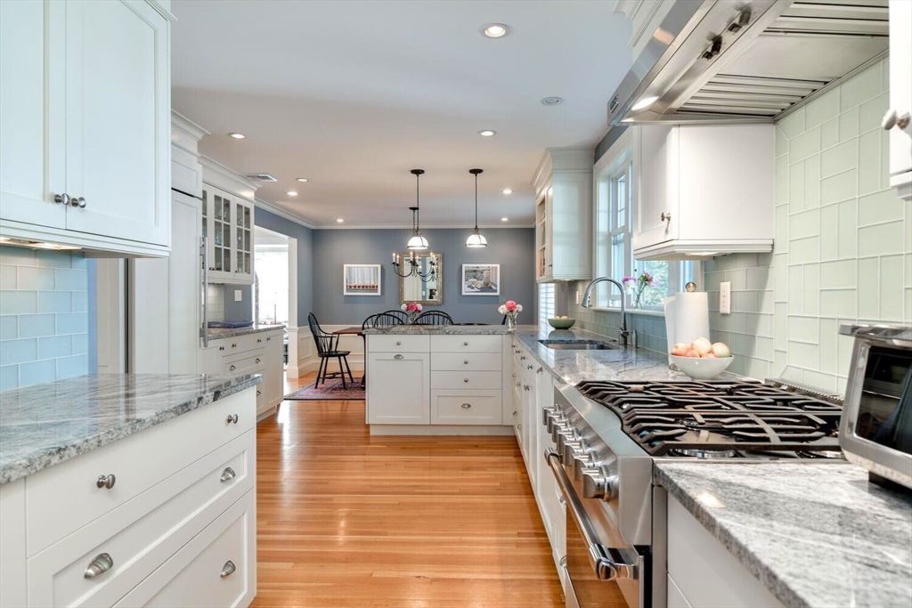 15 Selden Street Newton, MA 02468 - Photo 13 of 33 a kitchen with stainless steel appliances granite countertop a stove and a sink