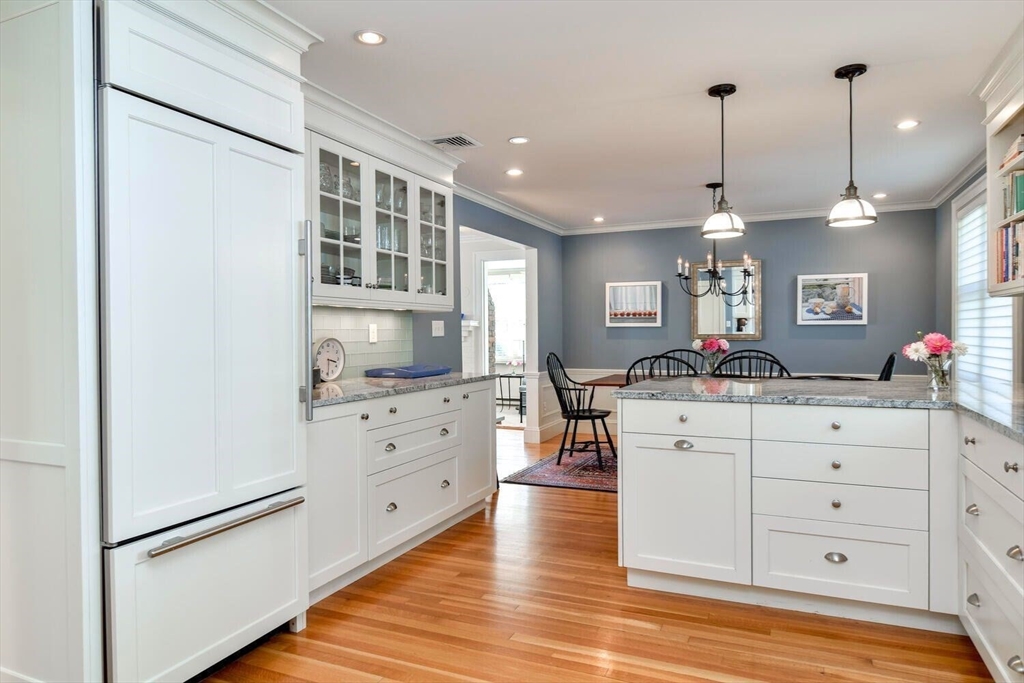 15 Selden Street Newton, MA 02468 - Photo 14 of 33 a kitchen with white cabinets and chandelier