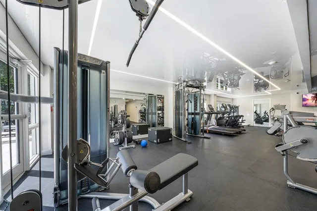 a room with gym equipment and a large window