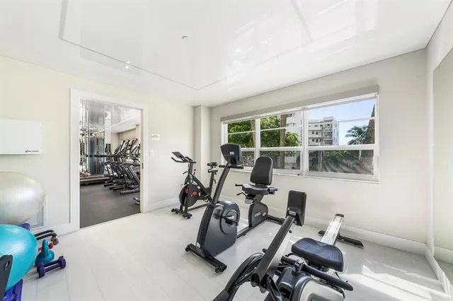 a kitchen with a dining table chairs sink and granite counter top