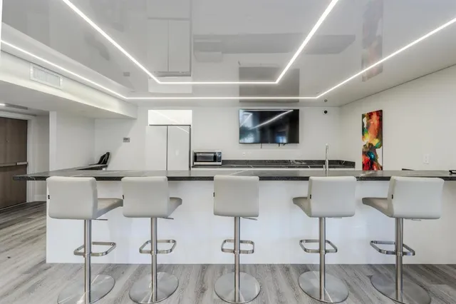 a view of a swimming pool with a bench and trees