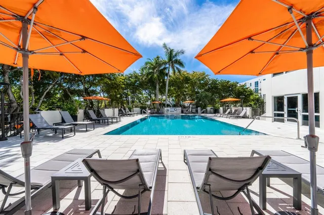 a view of a patio with a dining table and chairs under an umbrella
