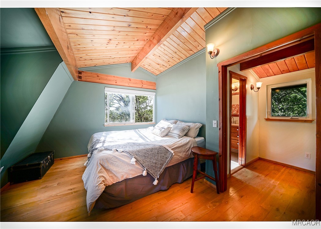 33469 Music Camp Road Running Springs, CA 92382 - Photo 18 of 27 a bed sitting in a bedroom next to a window