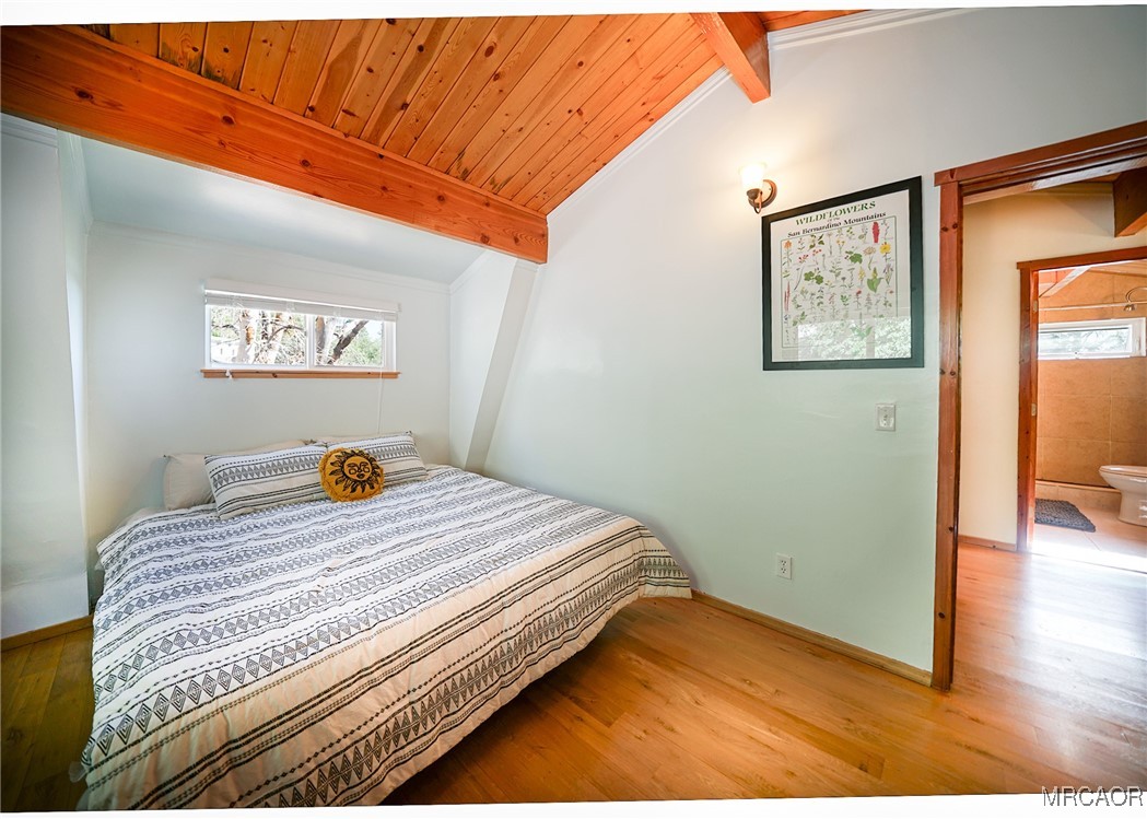 33469 Music Camp Road Running Springs, CA 92382 - Photo 22 of 27 a bedroom with a bed and painting on the wall