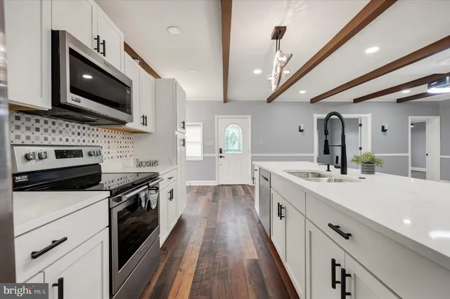 a kitchen with stainless steel appliances a stove microwave and cabinets