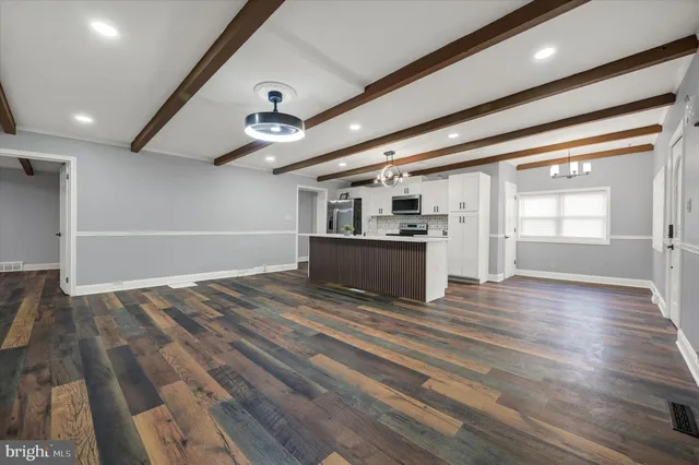 a view of a kitchen with a sink and cabinets