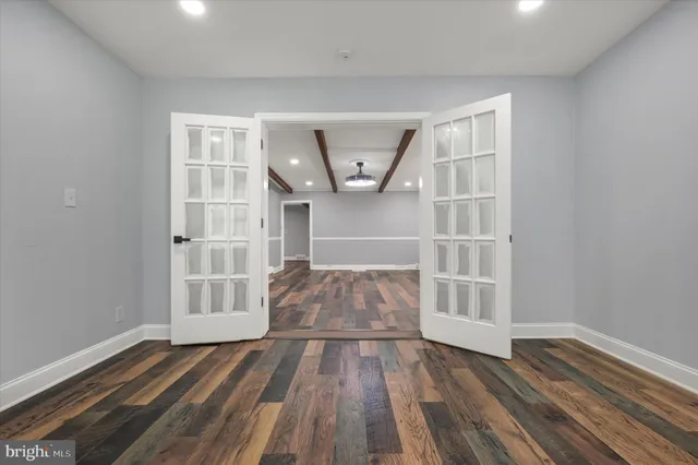wooden floor in an empty room with a window