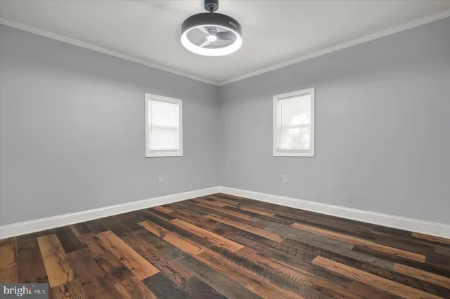 a view of a room that has a window and ceiling fan