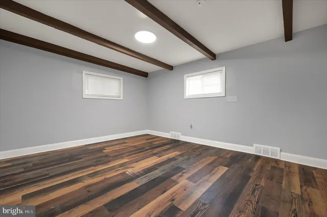 a view of a room with wooden floor and window