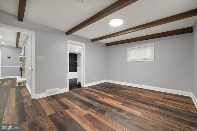 a view of a livingroom with wooden floor and staircase