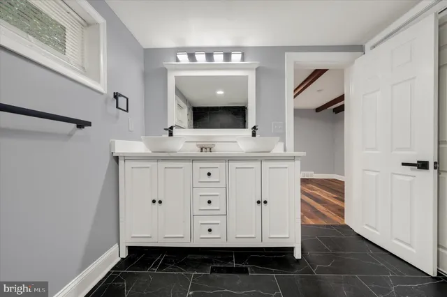 a bathroom with a sink and a mirror