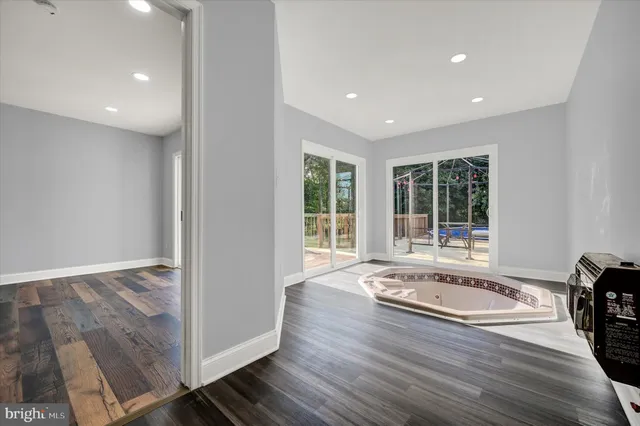 a view of wooden floor and window in a room