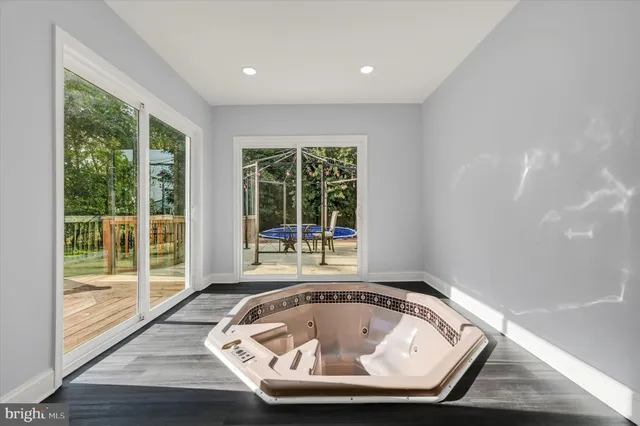 a view of bathroom with tub and window