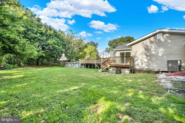 a view of a house with a yard and sitting area