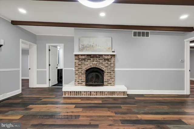 a living room with a fireplace and a fireplace